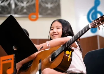How Can You Donate Guitar to Empower a Gold Star Family Through Gold Star Mentors? girl in guitar class