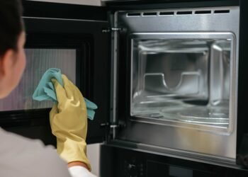 compressed woman yellow gloves cleaning oven