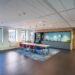 interior kitchen area modern office with long wooden table chairs