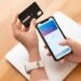person paying with its smartphone wallet app 23 2149167261.jpg
