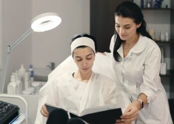 cosmetologist showing her patient innovations cosmetology 158595 4606
