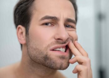 dental problems man checking his teeth looking disturbed 11zon