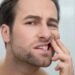dental problems man checking his teeth looking disturbed 11zon