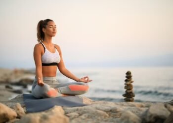 imgi 17 young woman practicing yoga relaxation exercises meditating rock beach copy space 637285 5473