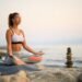imgi 17 young woman practicing yoga relaxation exercises meditating rock beach copy space 637285 5473