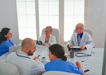 healthcare workers having meeting hospital conference room about symptoms patients analysing x ray clinic expert therapist talking with colleagues about disease medicine professional1