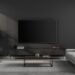 minimalist modern living room interior with flat screen tv wall mounted sleek black walls contemporary sofa low coffee table indoor plant and soft natural lighting photo 1