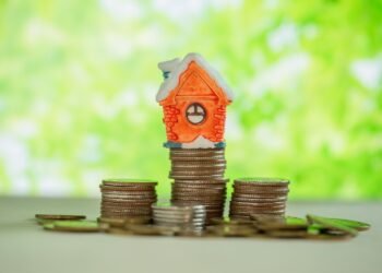 When Should Real Estate Investors Consider Private Money Lending? mini house stack coins with green blur 150kb